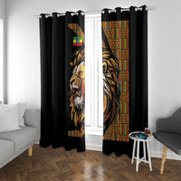 Black window curtain with lion face panel and red-green patterned border, two hanging curtains