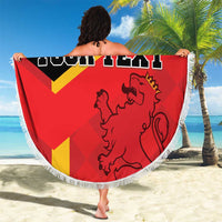 Large round beach blanket held out, Spain flag design with lion and custom text, fringed edge