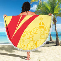 Round beach blanket with red lightning rays and gold icons, fringed edge