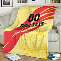 Spain football blanket draped on sofa: yellow/red '00 YOUR TEXT' with gold crown print