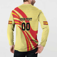 Yellow sweatshirt with button placket, back graphic with red diagonal stripes and large “00”.