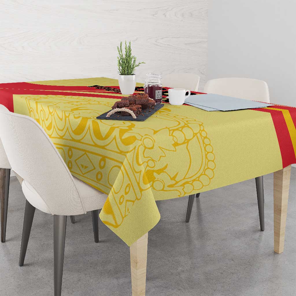 Yellow and red Spain-style tablecloth draped over dining table with chairs