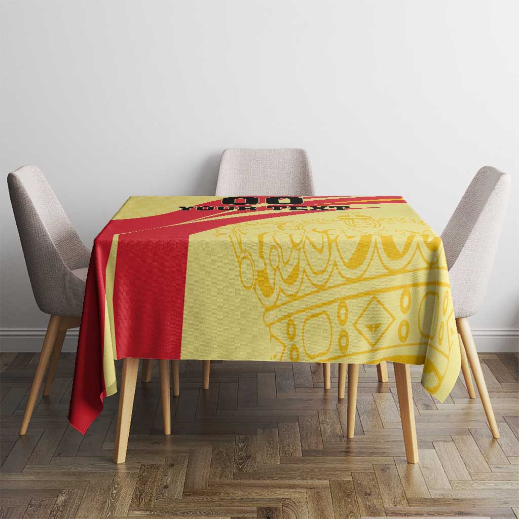 Yellow and red Spain-style tablecloth on square dining table with gray chairs