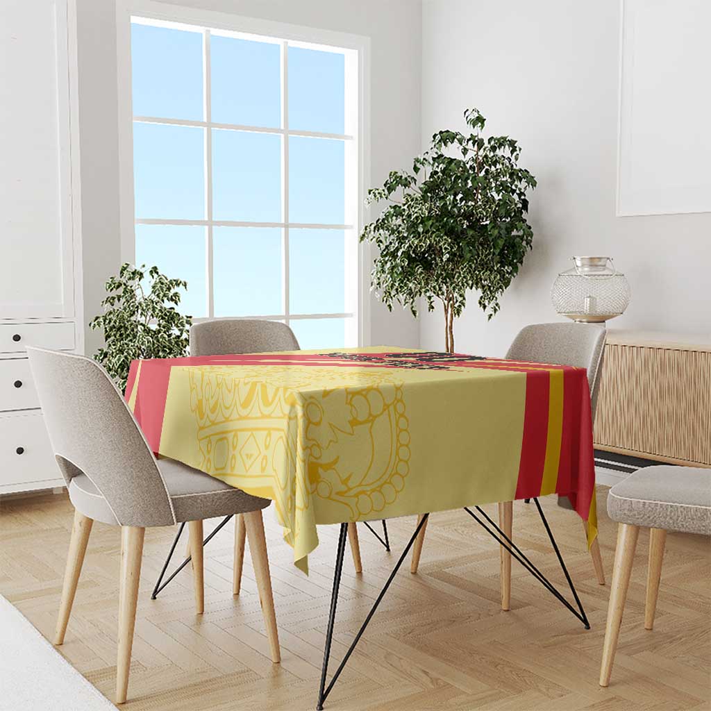 Yellow and red Spain-style tablecloth on rectangular table in a bright room