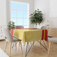 Yellow and red Spain-style tablecloth on rectangular table in a bright room