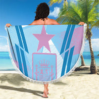Blue round beach blanket with fringe, large purple star and crown graphic, striped pattern