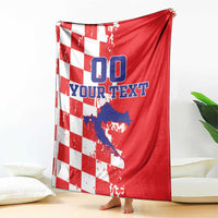 Red and white checkered blanket draped over a chair, showing “00” and custom text