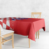 Red rectangular tablecloth draped over table with grunge checkerboard and map