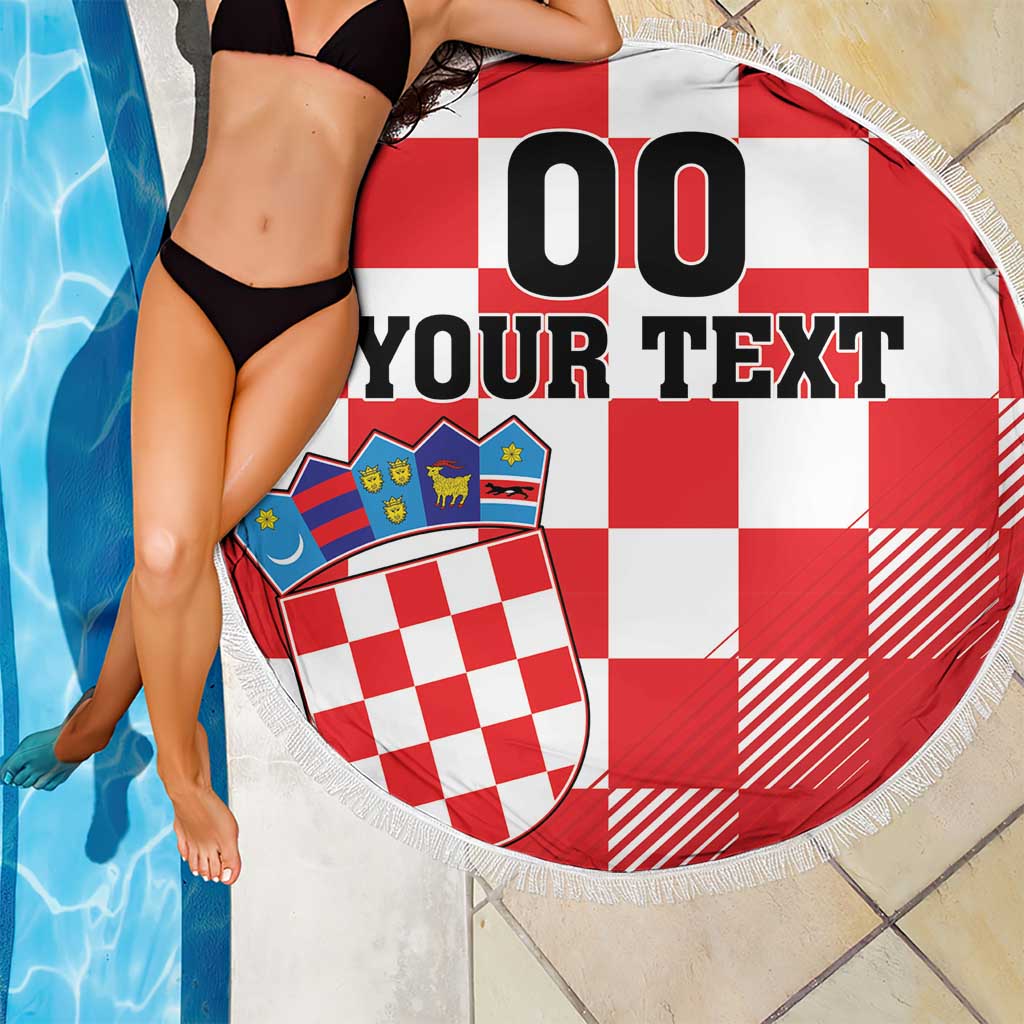 Round red-and-white checkerboard beach blanket with coat of arms and white fringe trim