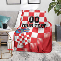 Croatia checkerboard custom blanket on gray couch, red and white checks, crest shield, “00 YOUR TEXT”