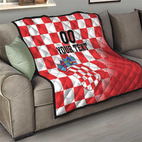 Red and white checkerboard quilt blanket with coat of arms patch and black 'YOUR TEXT' design