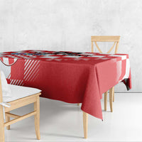 Red and white checkerboard tablecloth draped over dining table corner