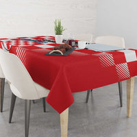 Red and white checkerboard tablecloth with hanging edge over dining table