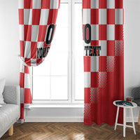 Red and white checkerboard curtains by a glass door, with coat of arms and custom text