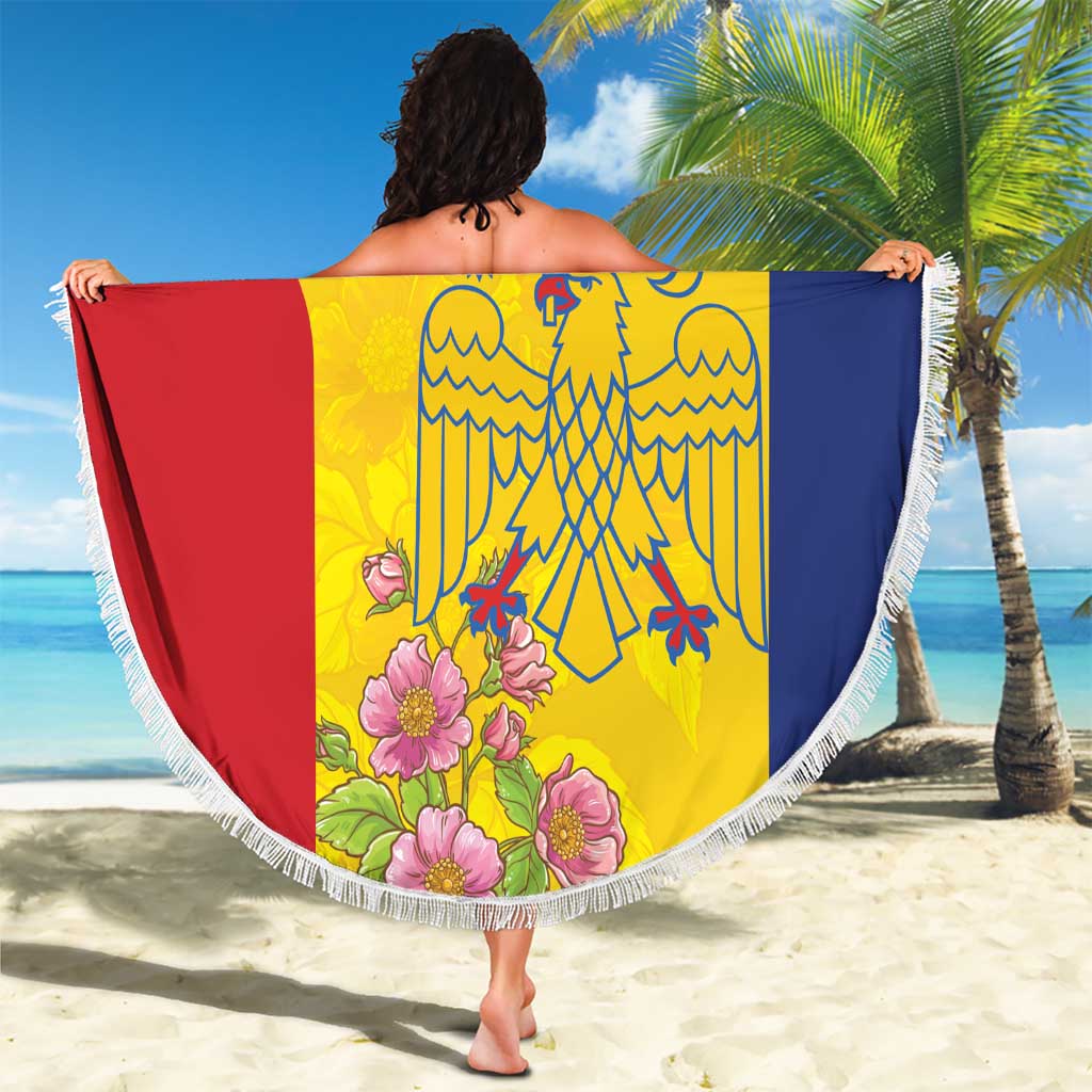 Round beach blanket with white fringe, yellow red blue eagle/crest artwork with flowers.