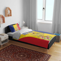 Flag-colored duvet cover and pillow set on bed, floral crest center panel and red trim