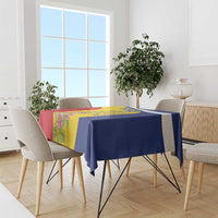 Tablecloth with dark blue top, yellow stripe, and floral panel draped over dining table