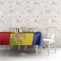 Tablecloth with blue border and yellow floral center draped over dining table