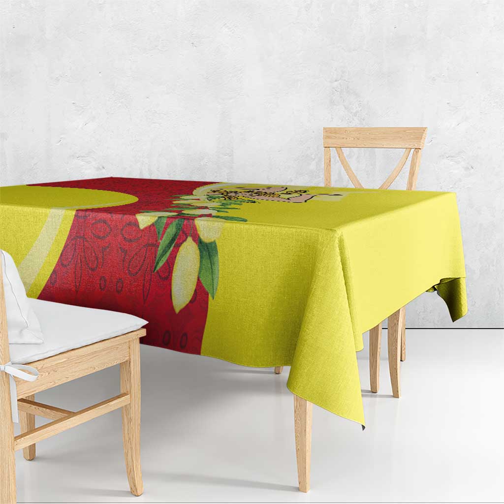 Yellow tablecloth with red floral strip and leaf motifs, side overhang and corner fold