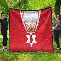 Red quilt blanket with Northern Ireland crest, white rays, and 'YOUR TEXT' on quilted surface