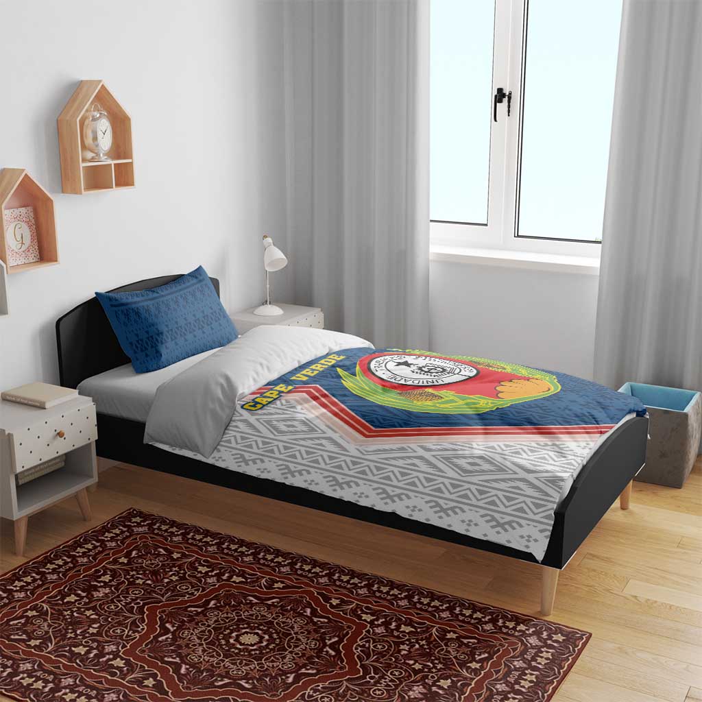 Blue and white duvet with emblem print and geometric design, two blue pillowcases.