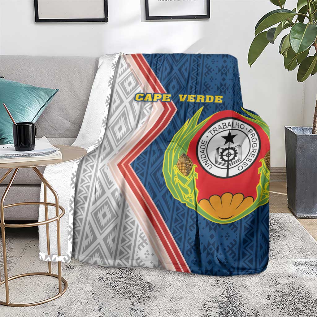 Cape Verde-themed blanket on floor with cape text, crest logo, and striped pattern