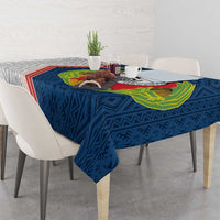 Blue tablecloth with Cape Verde crest centerpiece, draped over dining table corner