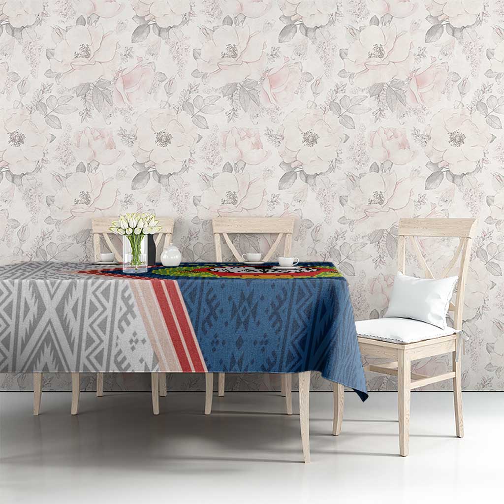 Blue Cape Verde tablecloth with emblem and geometric motifs, on table with chairs