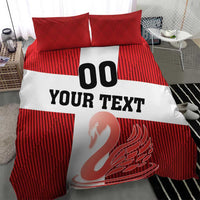 Red striped bedding set with white center stripe showing “YOUR TEXT” and swan emblem; two pillowcases