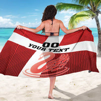 Red football sarong with white bands, custom text and number graphic shown from behind