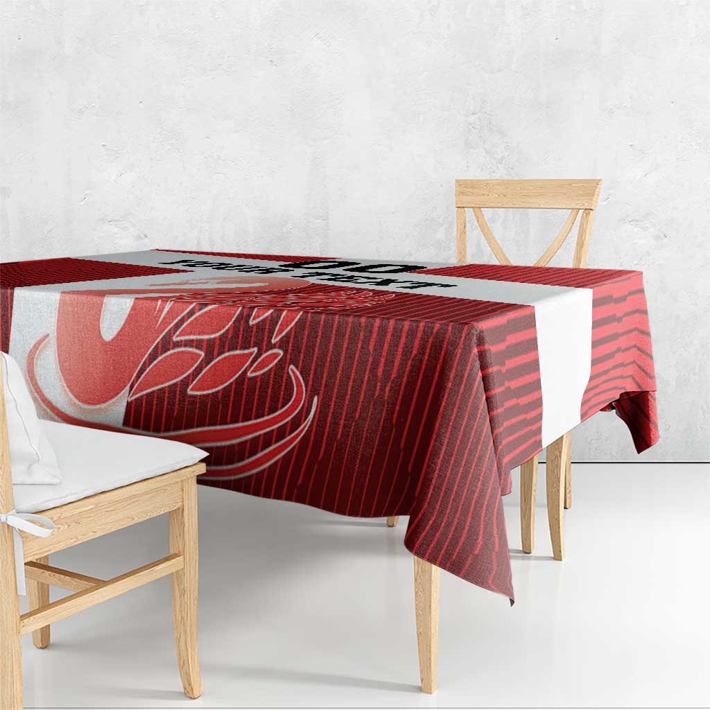 Red football tablecloth draped on table with white swan motif and striped pattern
