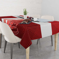 Red football tablecloth on dining table with bold white swan graphic centerpiece