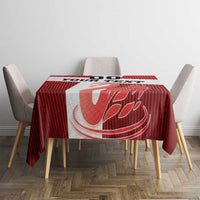 Red football tablecloth with centered white swan emblem on dining table