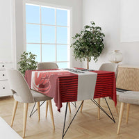 Red football tablecloth on dining table with chairs and white swan-striped design