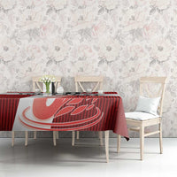 Red football tablecloth on table with large white swan graphic and red striped print