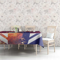 Blue and red striped tablecloth on a dining table in front of floral wallpaper