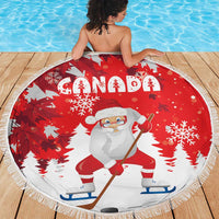 Red round Santa beach blanket with “Canada” text, snowflakes, and white fringe edge
