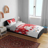 Red and white Christmas bedding set on bed with Santa hockey duvet and tree print pillows