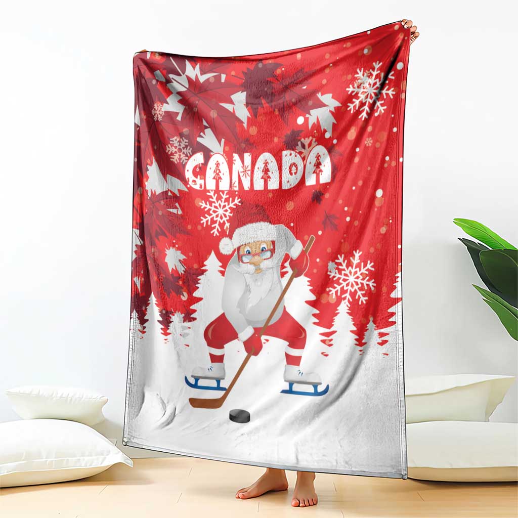Red Christmas blanket with Santa playing hockey, Canada lettering, and white snowflakes