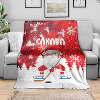 Red Christmas blanket with Santa on skates, Canada text, and scattered snowflake motifs