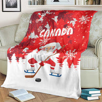 Red Christmas blanket with white Santa on skates, Canada text, and snowflake pattern