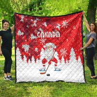 Red and white Canada Christmas quilt with Santa on skates, snowflakes, and pine trees