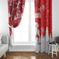 Red and white holiday window curtains with Santa and snowflake pattern, tied at the side