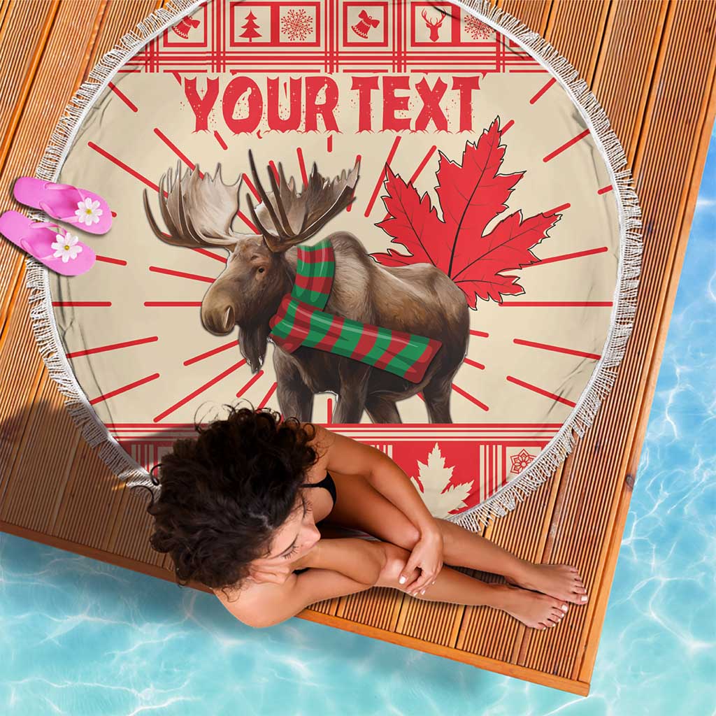 Round personalized beach blanket with moose in green scarf, red maple leaves, fringe, 'YOUR TEXT'.