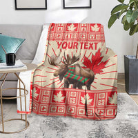 Personalized moose blanket over gray couch, red plaid maple leaves and Your Text design