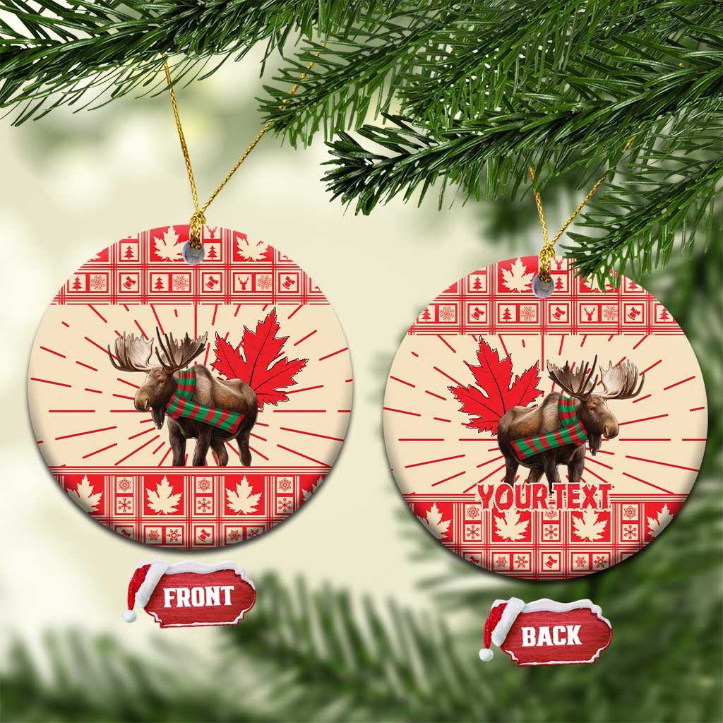 Round ceramic moose ornament with maple leaf red pattern, hanging on gold string, front/back tags