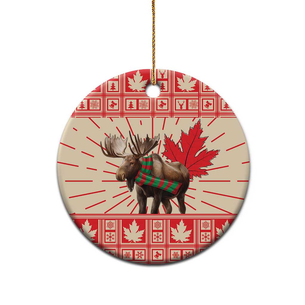 Round ceramic moose ornament with red-and-white maple leaf pattern, gold hanging string