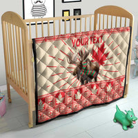 Personalized moose quilt blanket on baby bed in red and cream with maple leaf and YOUR TEXT