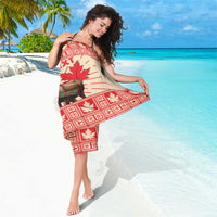 Red and cream moose maple leaf sarong worn and wrapped at the shoulders