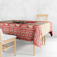 Red Christmas tablecloth with border pattern of moose and maple leaves